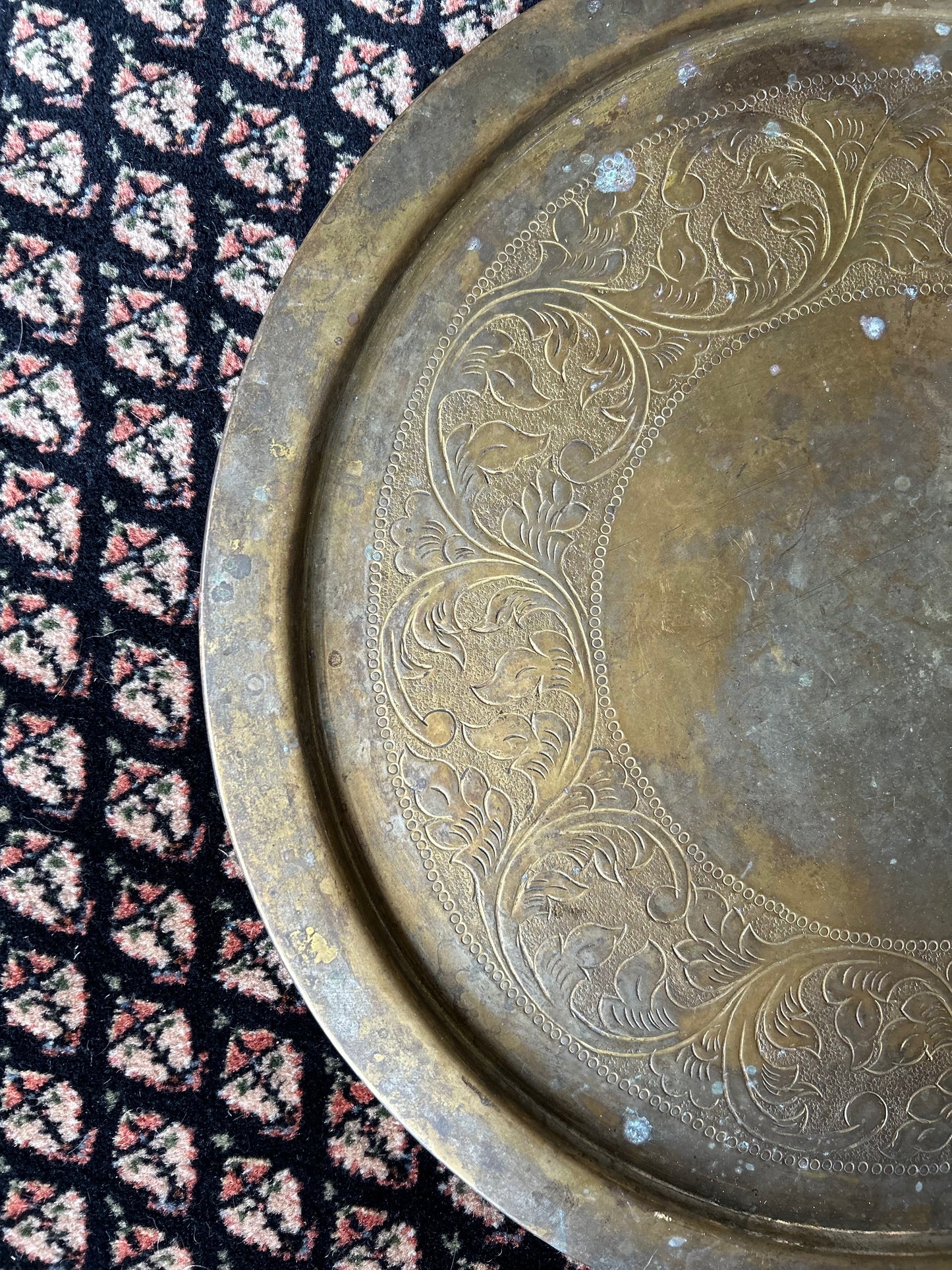 large brass platter with ornate carving